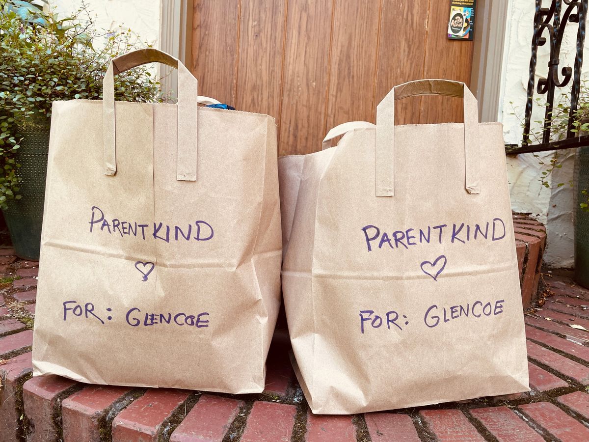 Two paper bags on a brick porch step, hand-lettered ParentKind and For: Glencoe